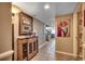 Hallway featuring tile floors and wall art leading to the kitchen and other areas of the home at 1625 S Ocean Blvd. # 1604, North Myrtle Beach, SC 29582