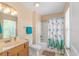 Bright bathroom featuring a tub, shower, and single sink at 1631 Low Country Pl. # E, Myrtle Beach, SC 29577