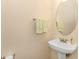 Simple and functional bathroom with pedestal sink, oval mirror, and neutral color scheme at 1631 Low Country Pl. # E, Myrtle Beach, SC 29577