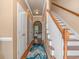 Inviting foyer with hardwood floors, staircase, and arched doorway leading to the living area at 1631 Low Country Pl. # E, Myrtle Beach, SC 29577