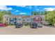 A row of townhomes featuring colorful exteriors and ample parking on a sunny day at 1631 Low Country Pl. # E, Myrtle Beach, SC 29577
