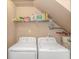 Functional laundry room includes a washer, dryer, shelving, and water heater at 1631 Low Country Pl. # E, Myrtle Beach, SC 29577