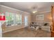 Bright living room with neutral carpeting, a ceiling fan, and large windows at 1631 Low Country Pl. # E, Myrtle Beach, SC 29577