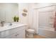 Bright bathroom with single vanity, neutral colored shower curtain and ceramic tile flooring at 166 Waterloo Sunset Dr., Longs, SC 29568