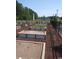 Community garden area with individual garden plots surrounded by a decorative black metal fence at 166 Waterloo Sunset Dr., Longs, SC 29568