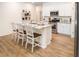 Stylish kitchen featuring white cabinets, stainless steel appliances, granite countertops, and a central island with seating at 166 Waterloo Sunset Dr., Longs, SC 29568