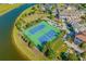 Aerial shot of community tennis courts, clubhouse, and surrounding lush landscaping at 168 West Palms Dr., Myrtle Beach, SC 29579