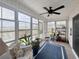 Relaxing sunroom with panoramic views, comfortable wicker seating, and stylish decor at 1856 Melville Ct., Little River, SC 29566
