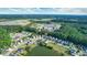Beautiful aerial view of a home nestled in a community with a pond and lush greenery, offering a serene setting at 190 Hamilton Way, Conway, SC 29526
