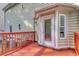 Spacious back door to deck with a white frame, windows and red wooden railing at 190 Hamilton Way, Conway, SC 29526