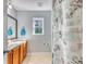 A bathroom with double sinks, a floral shower curtain, and a window providing natural light at 190 Hamilton Way, Conway, SC 29526