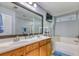 Bathroom featuring a double vanity, a large mirror, and a soaking tub at 190 Hamilton Way, Conway, SC 29526