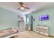 Bedroom with light blue walls, carpet, white dresser, ceiling fan, and a TV at 190 Hamilton Way, Conway, SC 29526