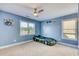 A bedroom with blue walls, carpeting, ceiling fan, a Batman bed, and two windows at 190 Hamilton Way, Conway, SC 29526