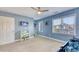 A bedroom with blue walls, carpeting, a TV, a baby's crib, and two windows at 190 Hamilton Way, Conway, SC 29526
