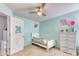 Bright bedroom with a ceiling fan, a white toddler bed, and a white dresser on carpet floors at 190 Hamilton Way, Conway, SC 29526