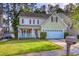 Inviting exterior of a two-story home featuring a cozy front porch, red shutters, and a well-manicured lawn at 190 Hamilton Way, Conway, SC 29526