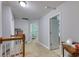 An upstairs hallway featuring neutral colors, a staircase with wood railing, and an open doorway at 190 Hamilton Way, Conway, SC 29526