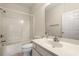 Bright bathroom features a shower-tub combo, toilet, and sink with mirror at 2000 Cross Gate Blvd. # 104, Surfside Beach, SC 29575