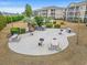 A round patio in the community area with picnic tables, grills, bicycle racks, and landscaped greenery at 2000 Cross Gate Blvd. # 104, Surfside Beach, SC 29575