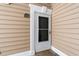 Unit 104 entrance showing door with decorative moulding and a green address plate at 2000 Cross Gate Blvd. # 104, Surfside Beach, SC 29575