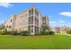 Apartment building featuring spacious screened in porches and a lush lawn at 2000 Cross Gate Blvd. # 104, Surfside Beach, SC 29575
