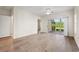 Bright living room featuring wood floors, ceiling fan, and sliding doors to a screened porch at 2000 Cross Gate Blvd. # 104, Surfside Beach, SC 29575