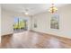 Spacious living room with wood flooring, ceiling fan, and sliding door to a patio at 2000 Cross Gate Blvd. # 104, Surfside Beach, SC 29575