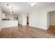 Open-concept living area with wood floors, white walls, and access to kitchen and other rooms at 2000 Cross Gate Blvd. # 104, Surfside Beach, SC 29575