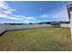 Spacious backyard featuring a well-maintained lawn, white privacy fence, and storage shed at 203 Golden Bear Circle, Longs, SC 29568