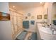 Well-lit bathroom featuring a double sink vanity and a shower with a decorative curtain at 203 Golden Bear Circle, Longs, SC 29568
