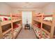 Bedroom featuring two sets of bunk beds with floral patterned bedding and natural light at 203 Golden Bear Circle, Longs, SC 29568