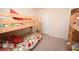 Bedroom featuring two sets of bunk beds with bright floral bedding and natural light at 203 Golden Bear Circle, Longs, SC 29568