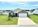 Charming brick home with a well-manicured lawn and a two-car garage, perfect for suburban living at 203 Golden Bear Circle, Longs, SC 29568