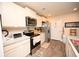 Well-equipped kitchen with white cabinets, stainless steel appliances, and ample countertop space for cooking at 203 Golden Bear Circle, Longs, SC 29568