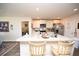 Bright kitchen featuring a large island with seating, modern appliances, and access to other rooms at 203 Golden Bear Circle, Longs, SC 29568