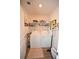 Functional laundry room featuring modern white washer and dryer, organized shelving at 203 Golden Bear Circle, Longs, SC 29568