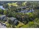 Aerial view of condos overlooking the golf course, ponds, and trees, blending residential living with nature at 227 Pinehurst Ln. # 6D, Pawleys Island, SC 29585