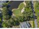 Aerial view of golf course next to a pond and tree line, offering a scenic recreational opportunity at 227 Pinehurst Ln. # 6D, Pawleys Island, SC 29585