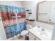 Cozy bathroom featuring an anchor-themed shower curtain, shelving, and a tiled mirror at 227 Pinehurst Ln. # 6D, Pawleys Island, SC 29585