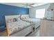 Bright bedroom with a blue accent wall, two beds, and ample natural light creating a relaxing atmosphere at 227 Pinehurst Ln. # 6D, Pawleys Island, SC 29585