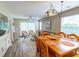Dining area with a large wooden table open to the living room and view of outdoor light at 227 Pinehurst Ln. # 6D, Pawleys Island, SC 29585