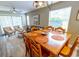 Dining area with a wooden table, seating for six, and view into the living room at 227 Pinehurst Ln. # 6D, Pawleys Island, SC 29585