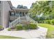 Charming two-story condo with inviting entrance, lush landscaping, and a well-manicured lawn at 227 Pinehurst Ln. # 6D, Pawleys Island, SC 29585