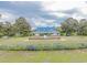 Sprawling traditional home with manicured front lawn, mature trees, and inviting water feature at 227 Pinehurst Ln. # 6D, Pawleys Island, SC 29585