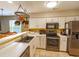 Bright kitchen with white cabinets, stainless steel appliances, and open to dining area at 227 Pinehurst Ln. # 6D, Pawleys Island, SC 29585