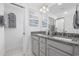 Bright bathroom featuring double vanity with granite countertops, modern fixtures, and elegant decorative touches at 2409 Seabreeze Pl., Myrtle Beach, SC 29577