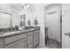 Well-lit bathroom with a double vanity featuring granite countertops, stylish fixtures, and a separate water closet at 2409 Seabreeze Pl., Myrtle Beach, SC 29577