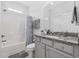 Well-lit bathroom boasts granite countertops, shower-tub combo and updated fixtures at 2409 Seabreeze Pl., Myrtle Beach, SC 29577