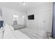 Bright bedroom featuring two beds, modern decor, and an ensuite bathroom for convenience at 2409 Seabreeze Pl., Myrtle Beach, SC 29577